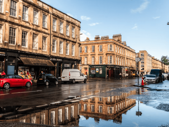 A stock photo of a street in Glasgow emphasising a row of above-shop flats
