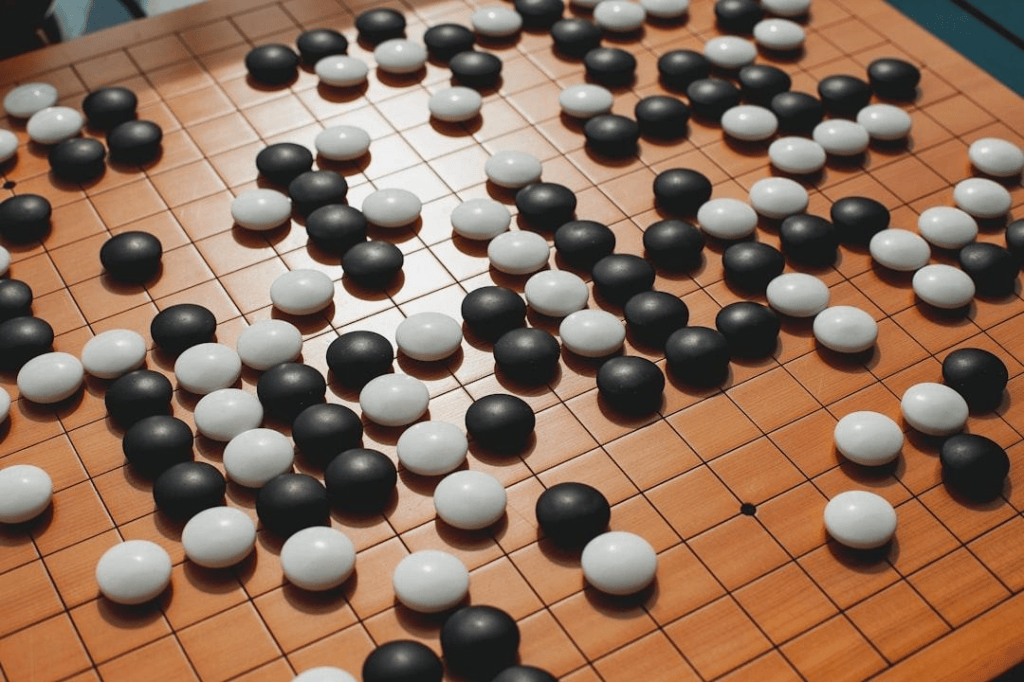 A Go board in an advanced state - to the lay observer, it is not clear whether white or black is winning.
